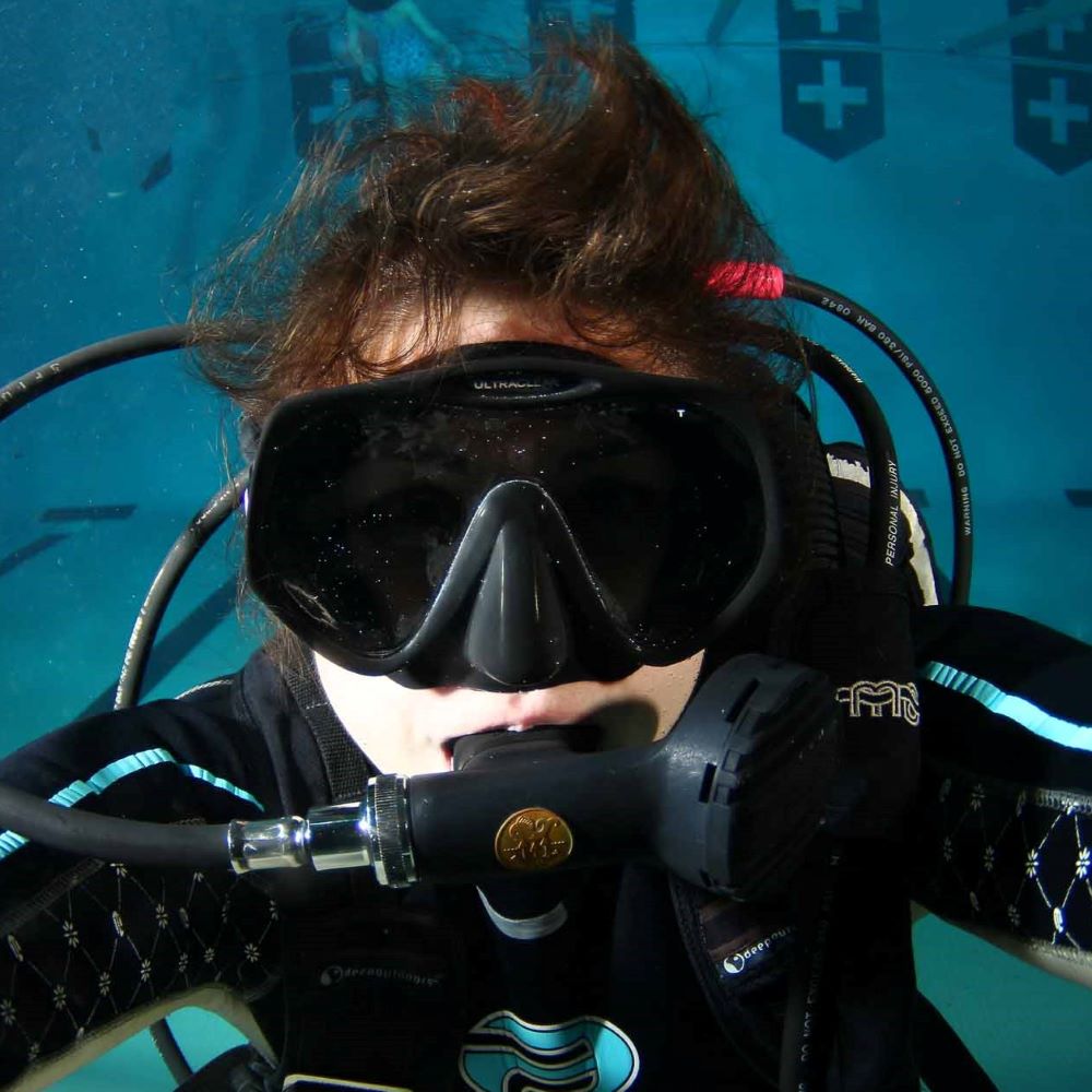 Friends laughing while gearing up for a local dive day