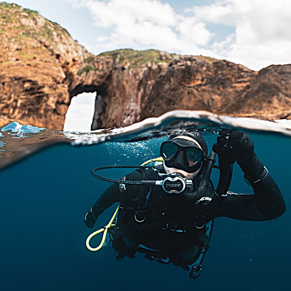 Young adults at the water preparing for a dive day